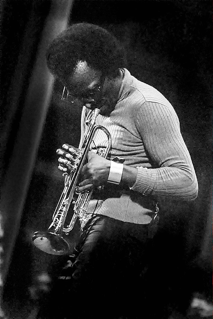 Miles Davis playing trumpet on stage in 1971|