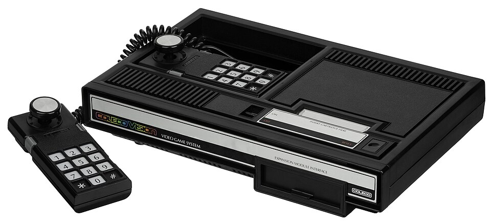 A wedge-shaped console with a cartridge slot and a rectangular keypad controller with a short joystick.