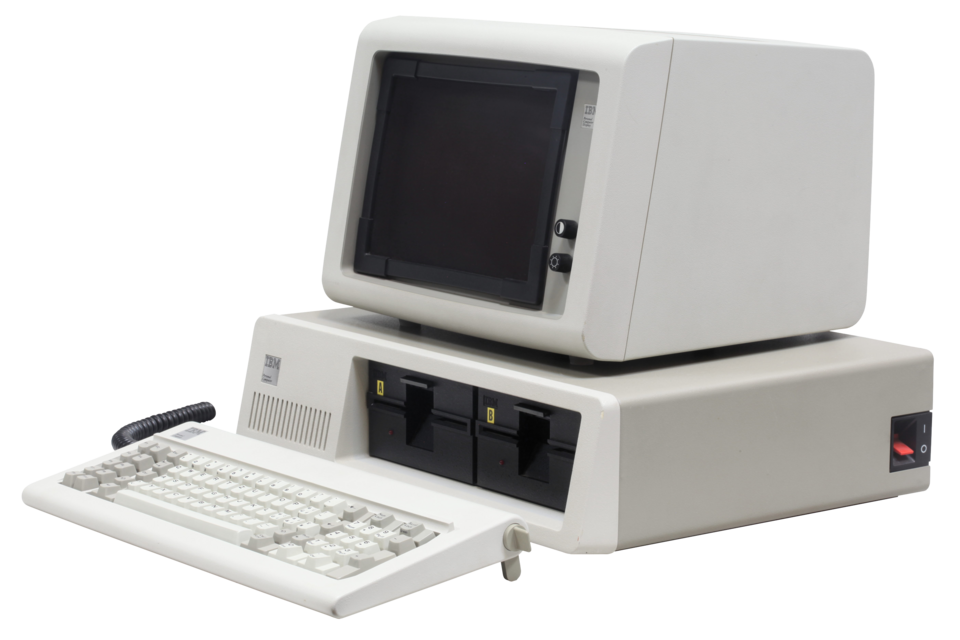 A beige IBM Personal Computer with monitor and keyboard on display.