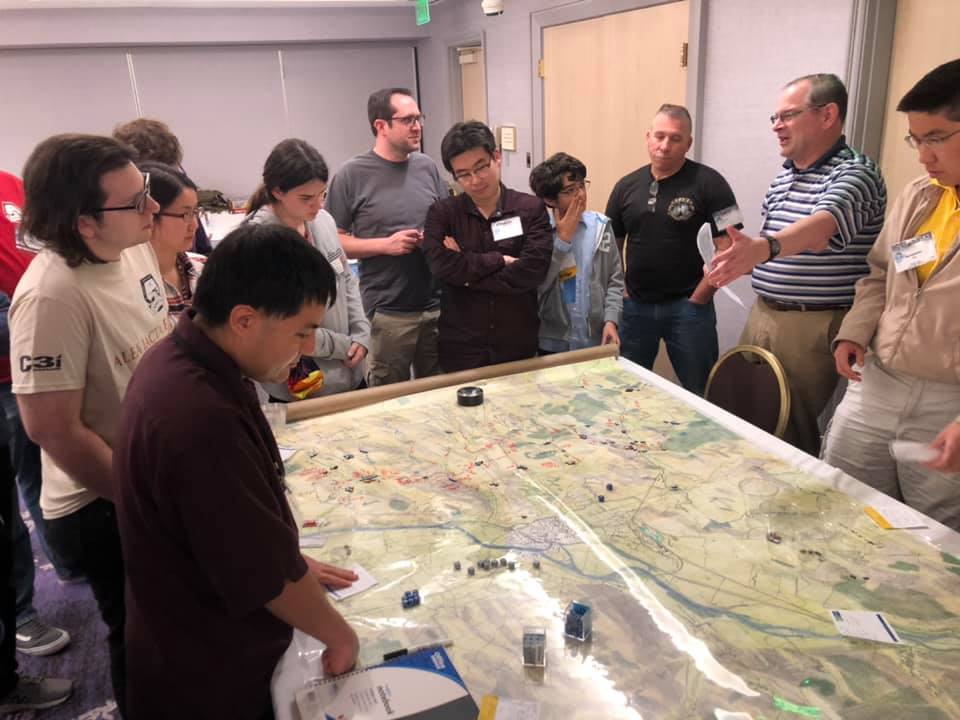 A topographical map overlaid with a plastic sheet bearing handwritten notes and unit markers.