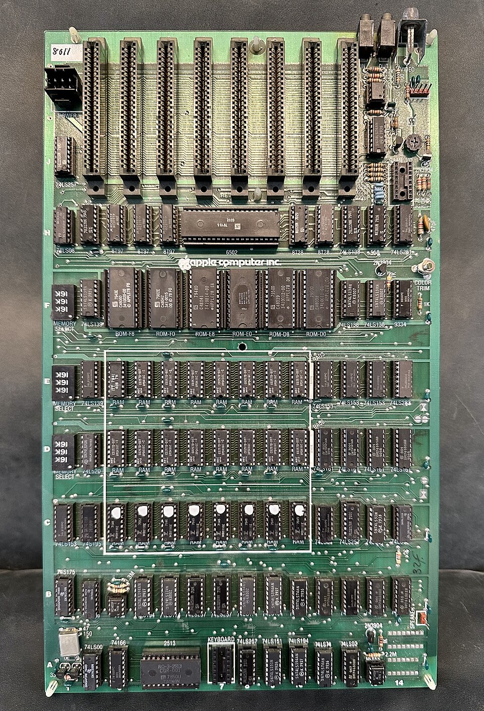 Vintage Apple II circuit board with chips and expansion slots.