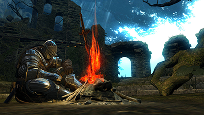 A glowing bonfire marked by a coiled sword rising from ashes in Dark Souls.