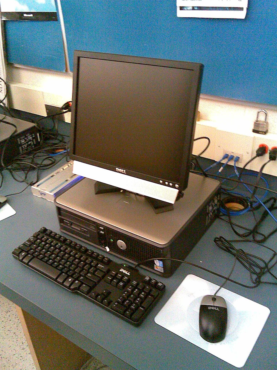 A desktop PC tower beside a flat-panel monitor on a desk.