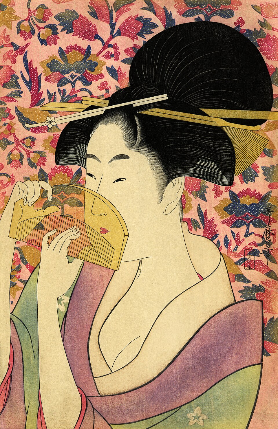 Woodblock print of a woman's face beside a comb by Utamaro|
