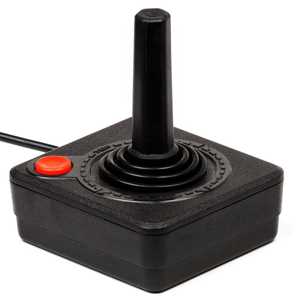 A black Atari 2600 joystick controller with a red fire button.