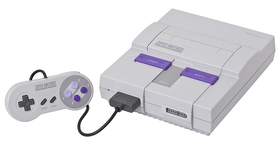 A gray Super Nintendo Entertainment System console shown with a purple-buttoned controller.