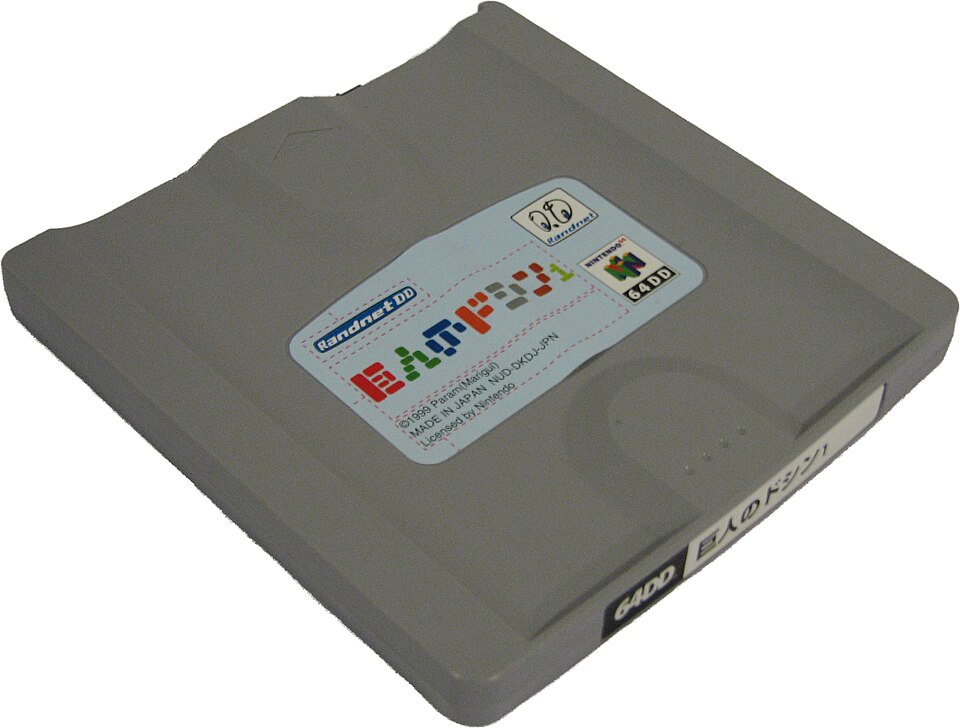 A magnetic 64DD game disk labeled Doshin the Giant.